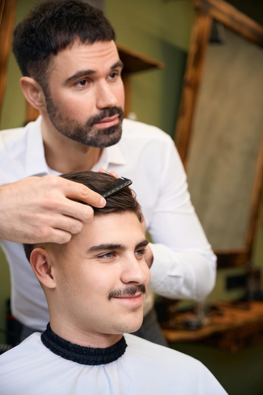Man Hairstylist Serving Client With Mustache